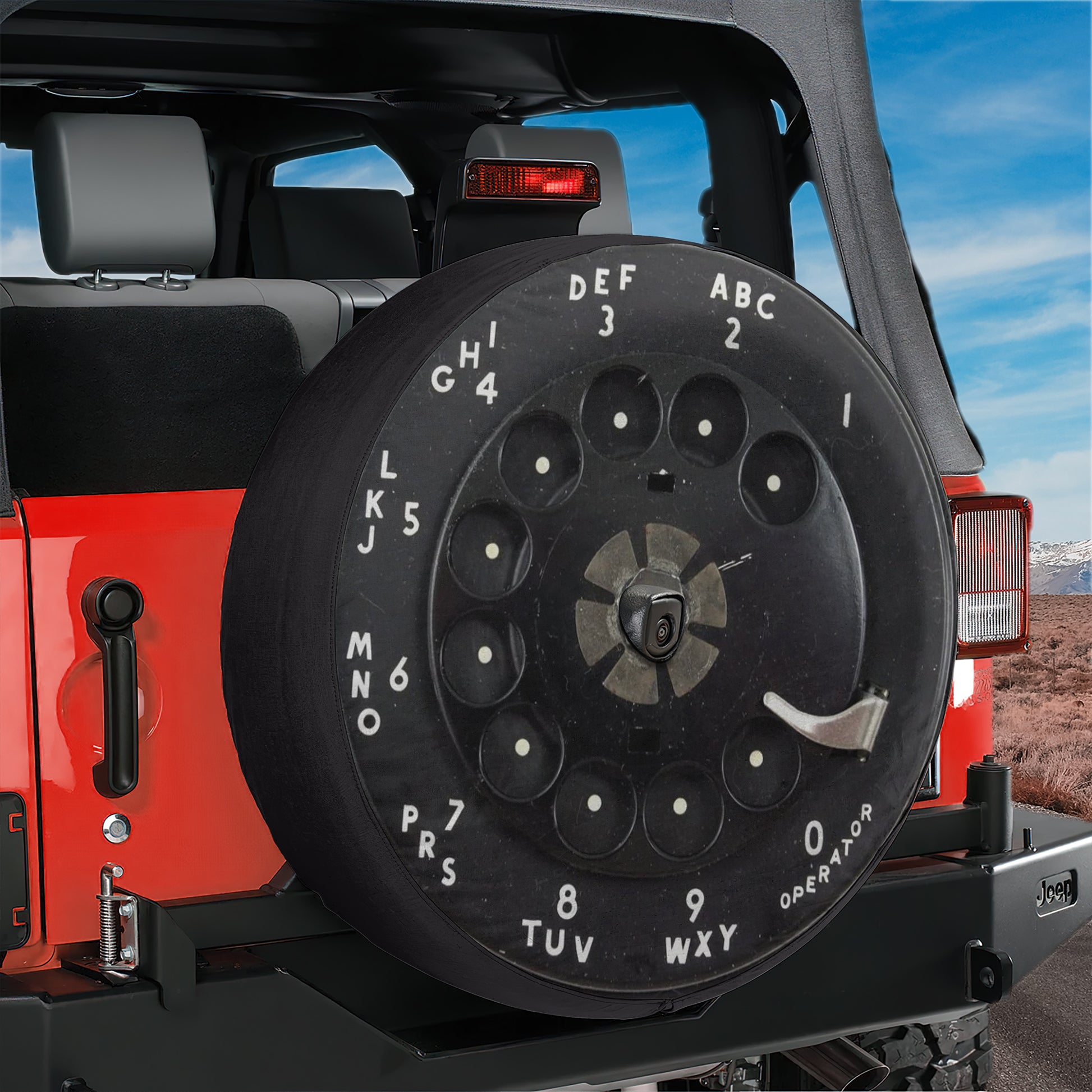 a spare tire mounted on the rear of a Jeep, with the alphabet letters on it.