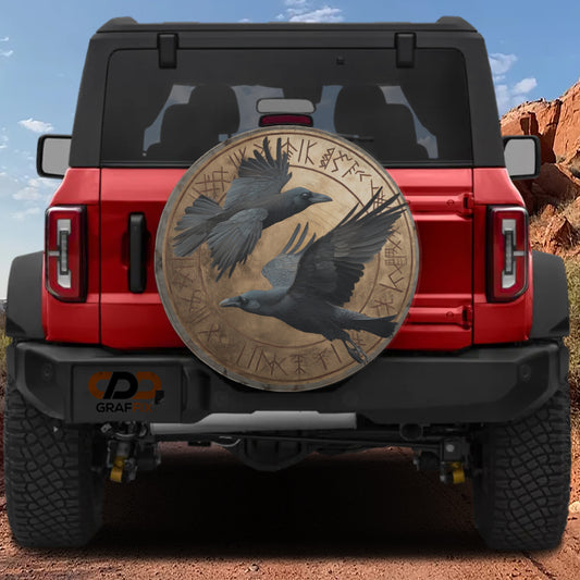 a red Jeep Wrangler with a large circular decal on the rear window depicting two black ravens in flight.
