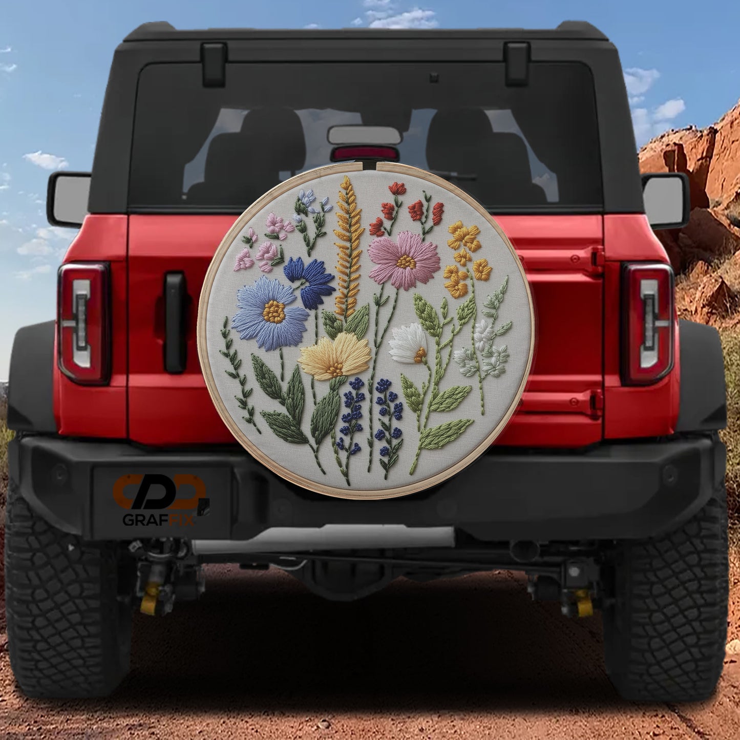 a red Jeep Wrangler with a large embroidered floral design on the rear window.