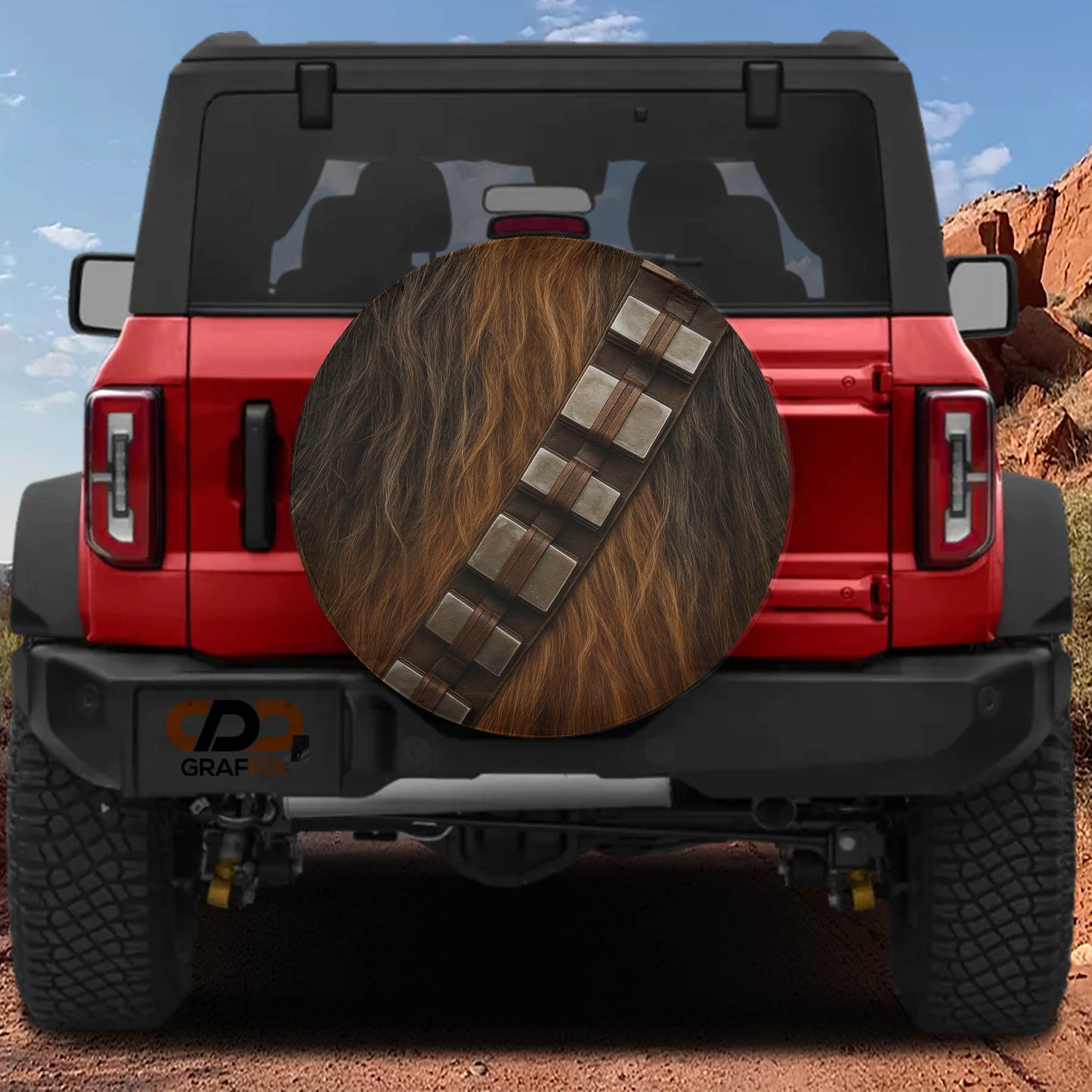 a red Jeep Wrangler with a Star Wars-themed spare tire cover on the rear.