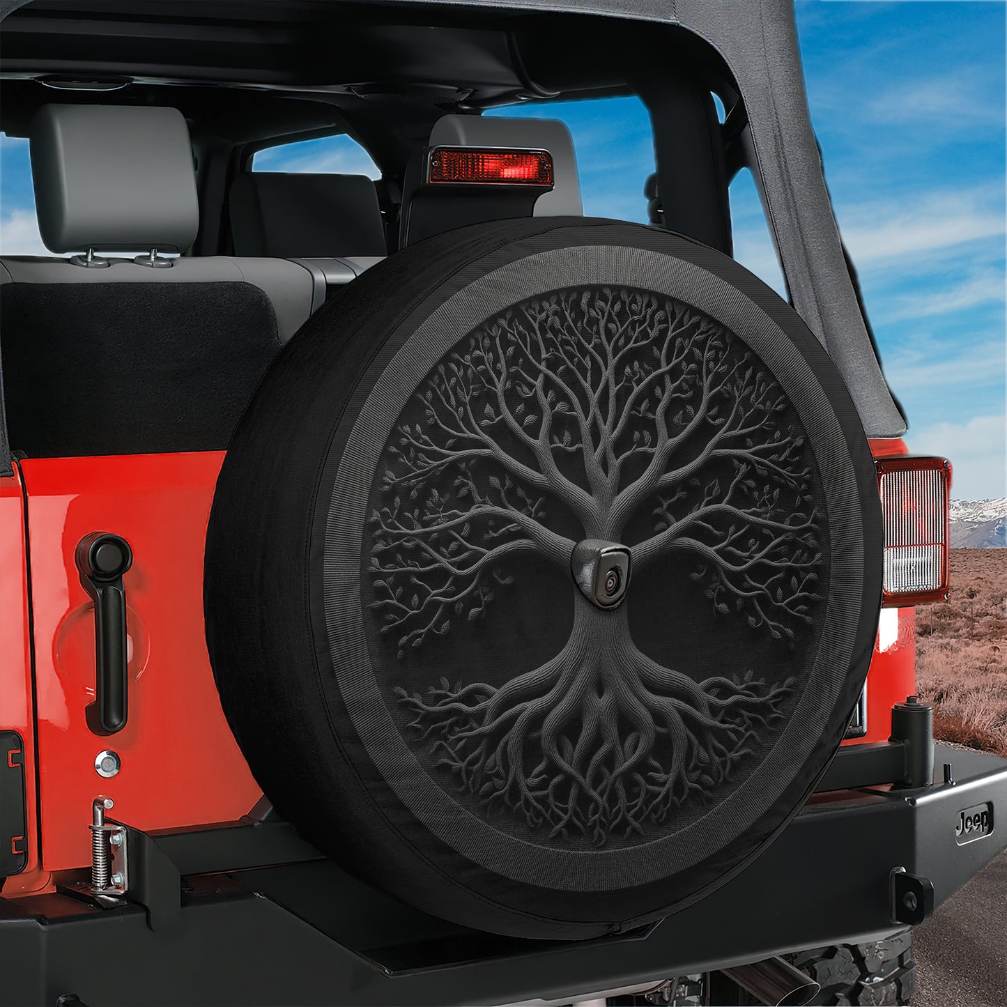 A red Jeep with a black tree-like design on the spare tire cover.