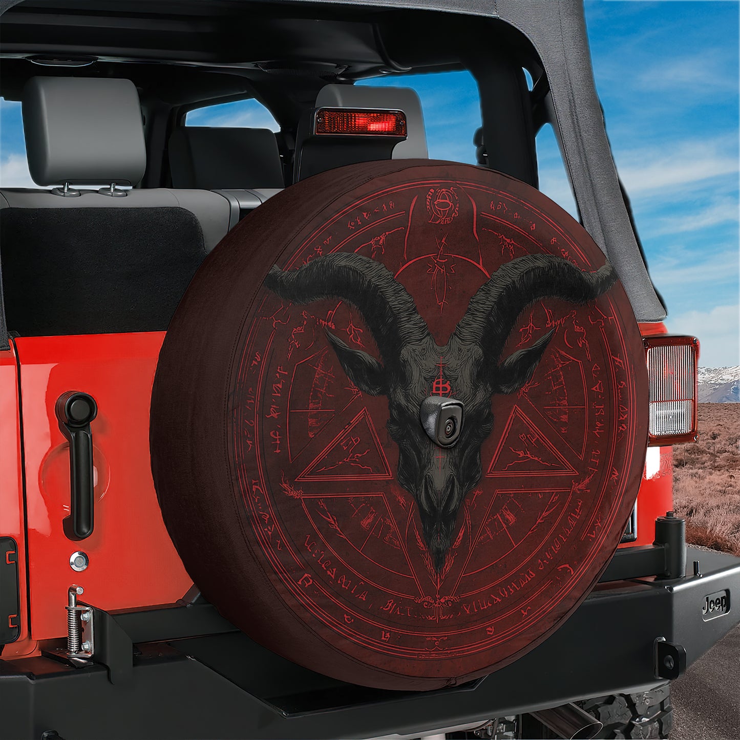 A red Jeep Wrangler with a large, detailed horned design on the spare tire cover.