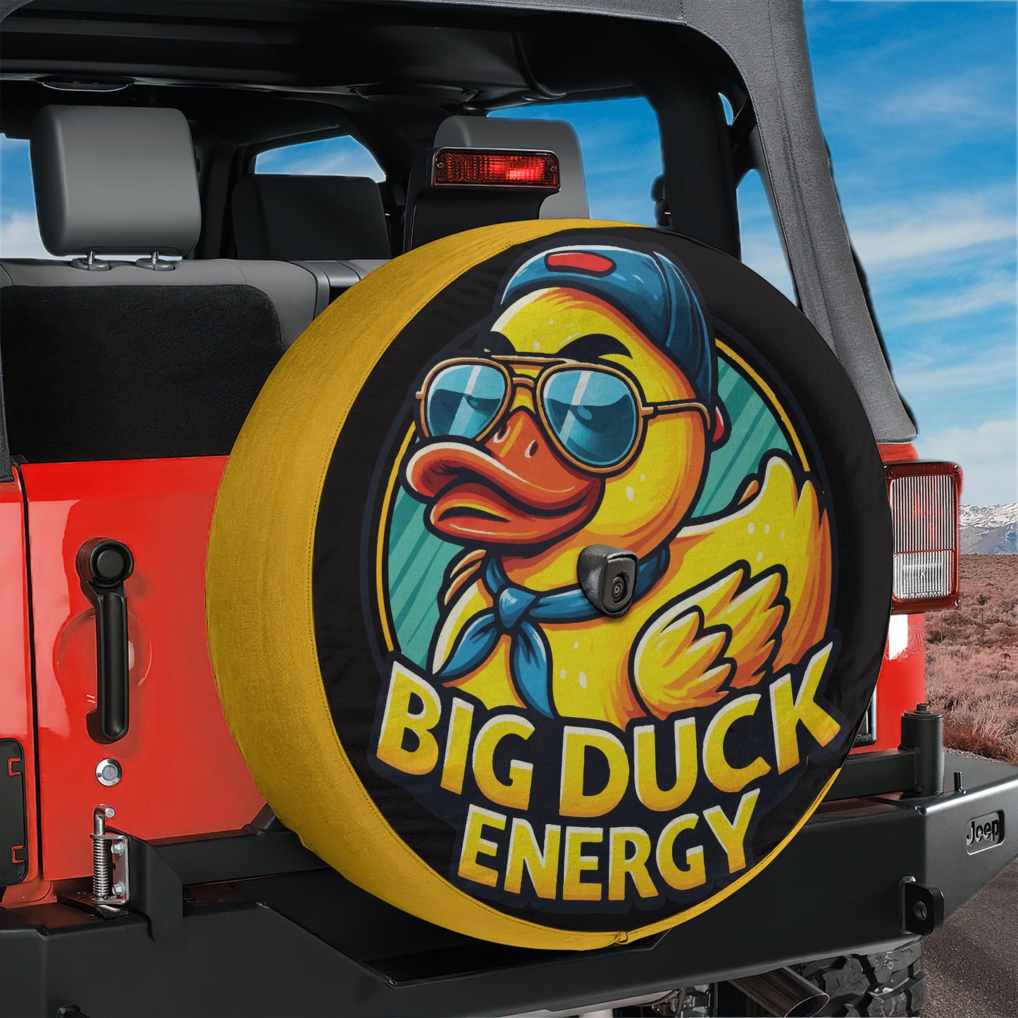 A tire cover with a cartoon duck wearing sunglasses and a baseball cap, with the text "BIG DUCK ENERGY" printed on it.