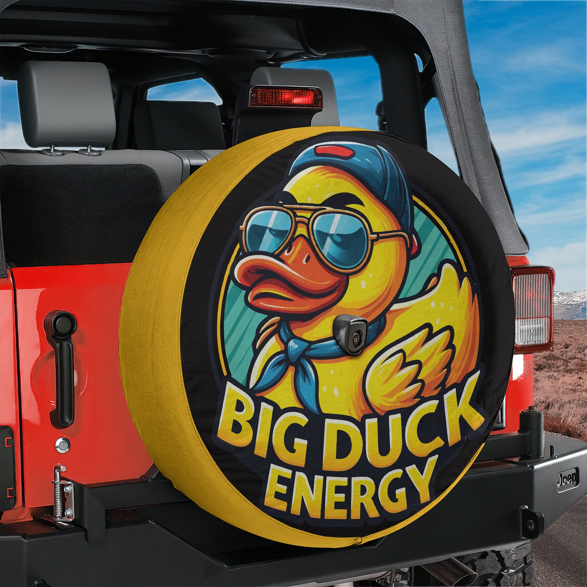 A tire cover with a cartoon duck wearing sunglasses and a baseball cap, with the text "BIG DUCK ENERGY" printed on it.