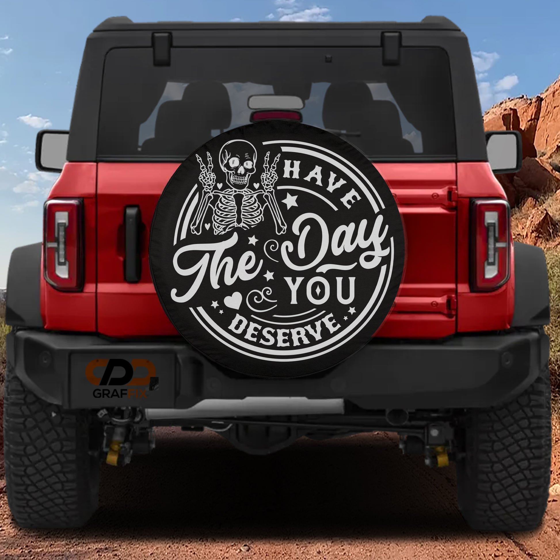 a red Jeep Wrangler with a large black tire cover on the rear of the vehicle.