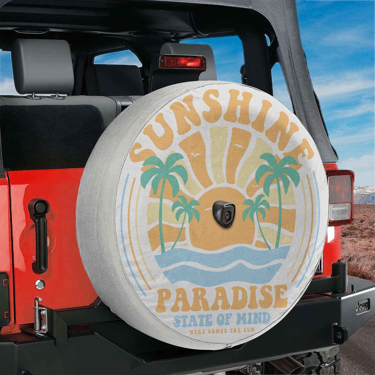 A red Jeep Wrangler with a large tire cover featuring a beach scene and palm trees.