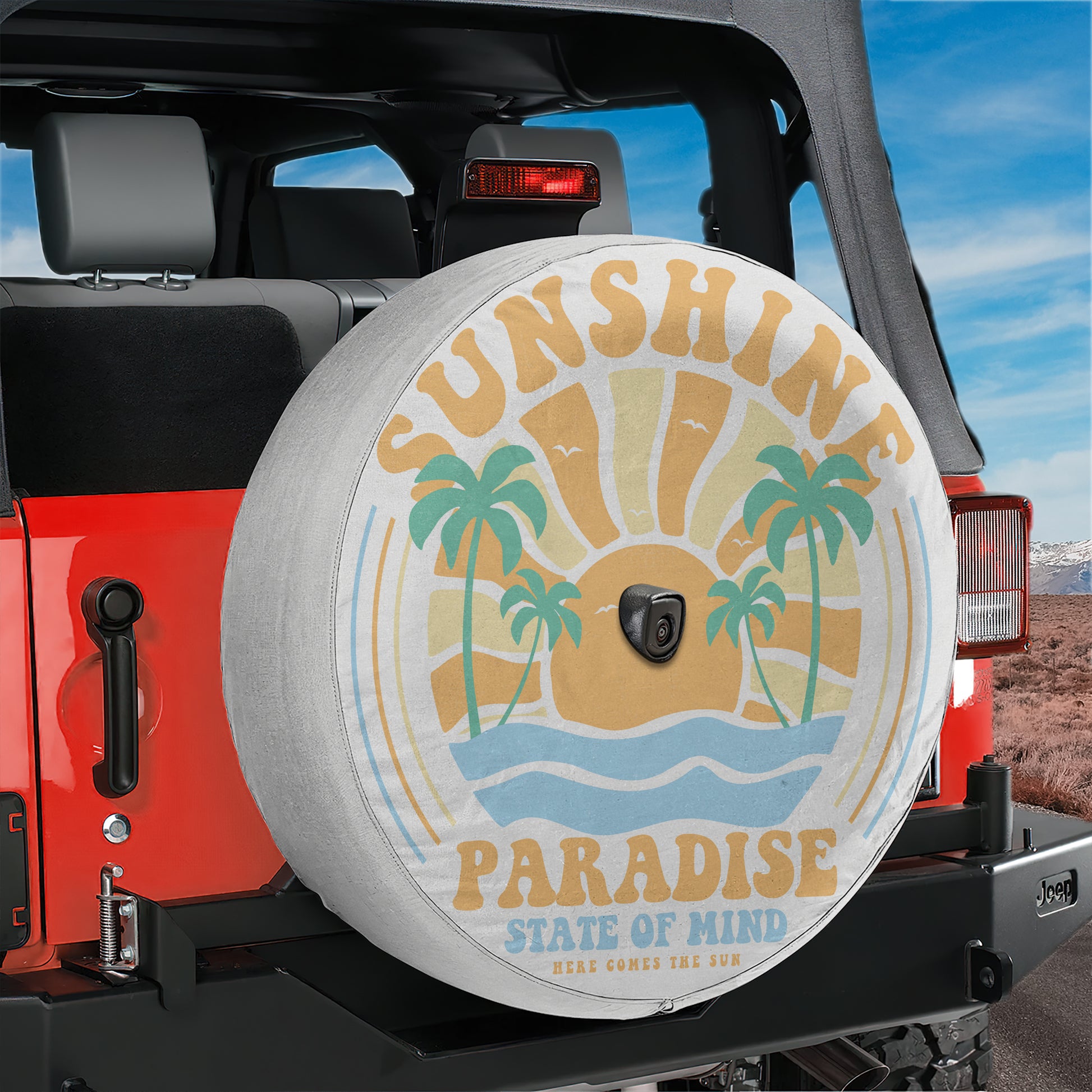 A red Jeep Wrangler with a large tire cover featuring a beach scene and palm trees.