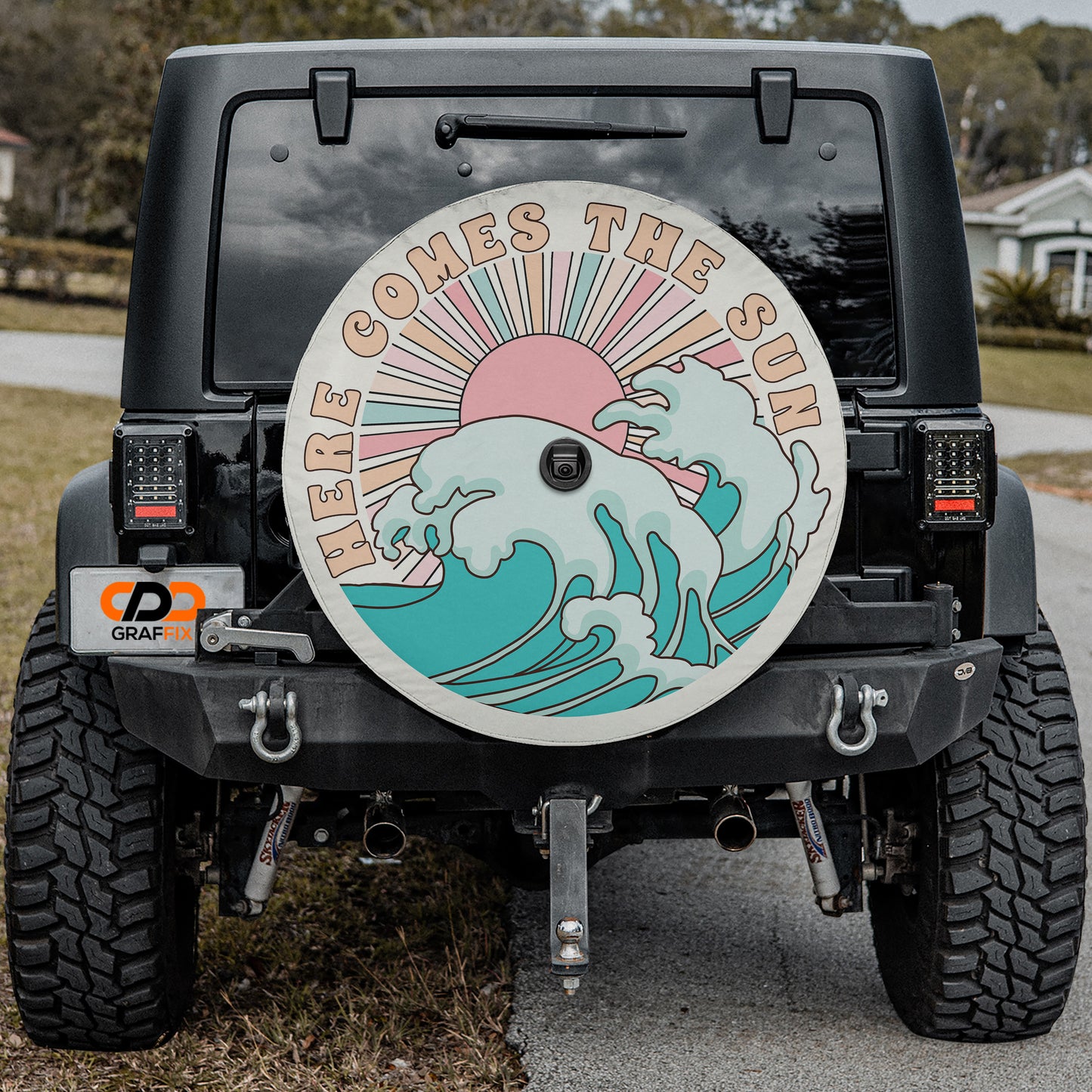 the rear of a black Jeep Wrangler with a large surfboard-shaped decal on the rear window.