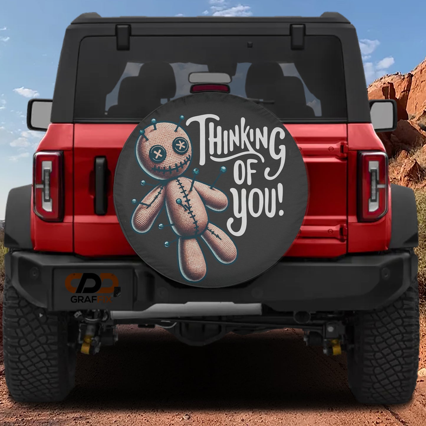 a red Jeep Wrangler with a tire cover that has a cartoon character and the text "Thinking of You!" printed on it.