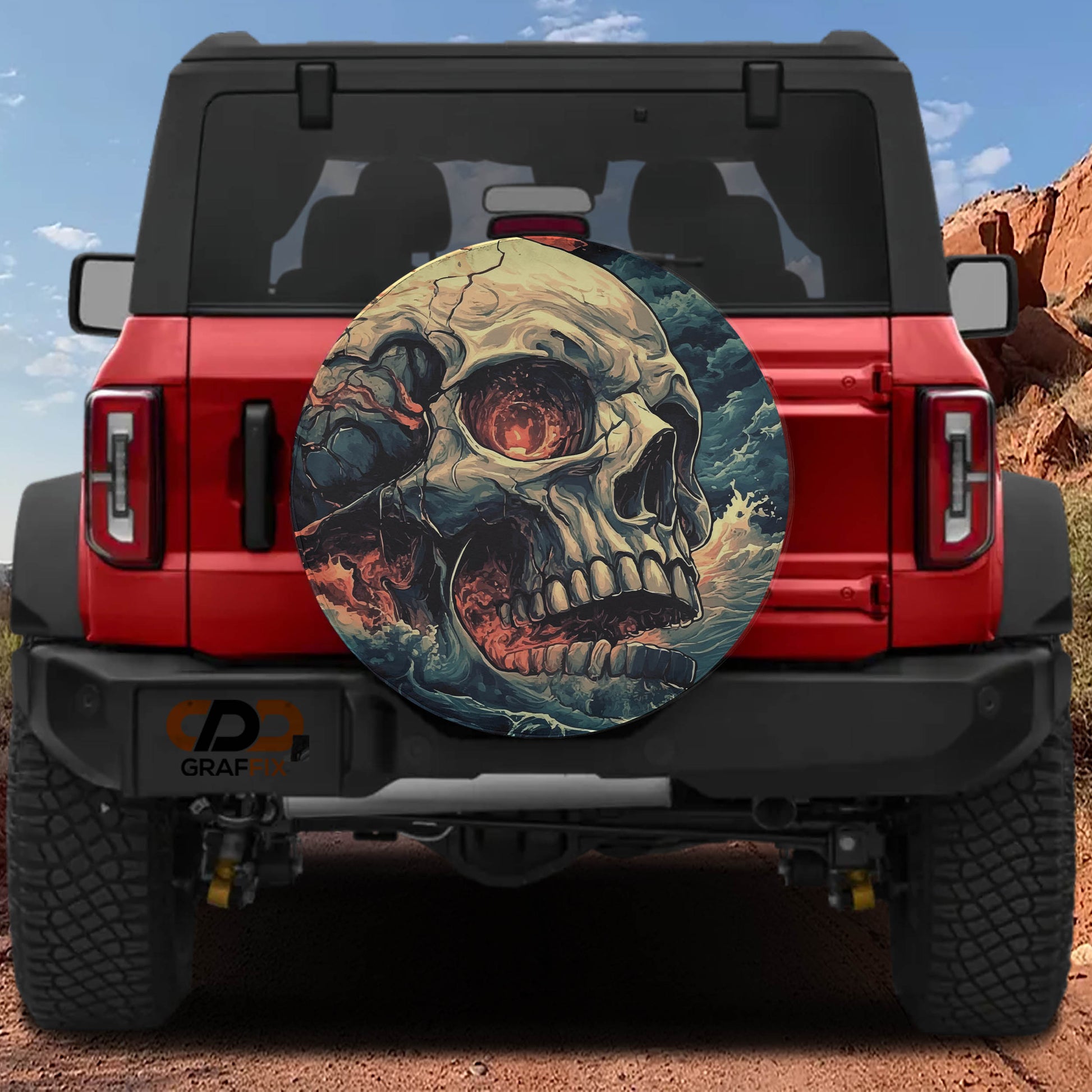 a red Jeep Wrangler with a skull-themed spare tire cover attached to it.