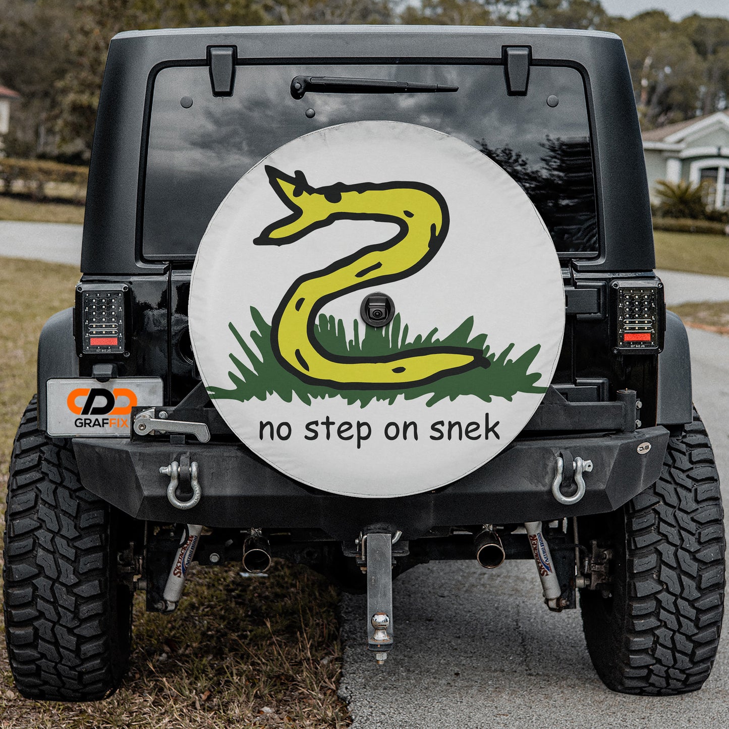 a white and black jeep with a yellow snake on it