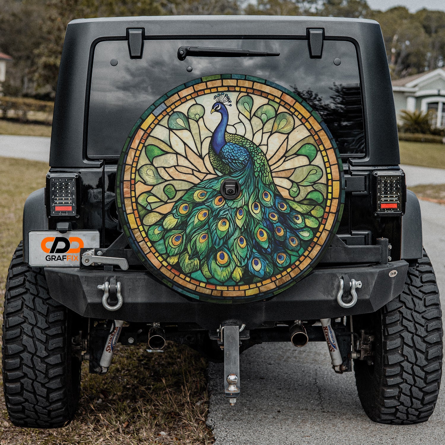 a colorful peacock painted on the back of a black jeep