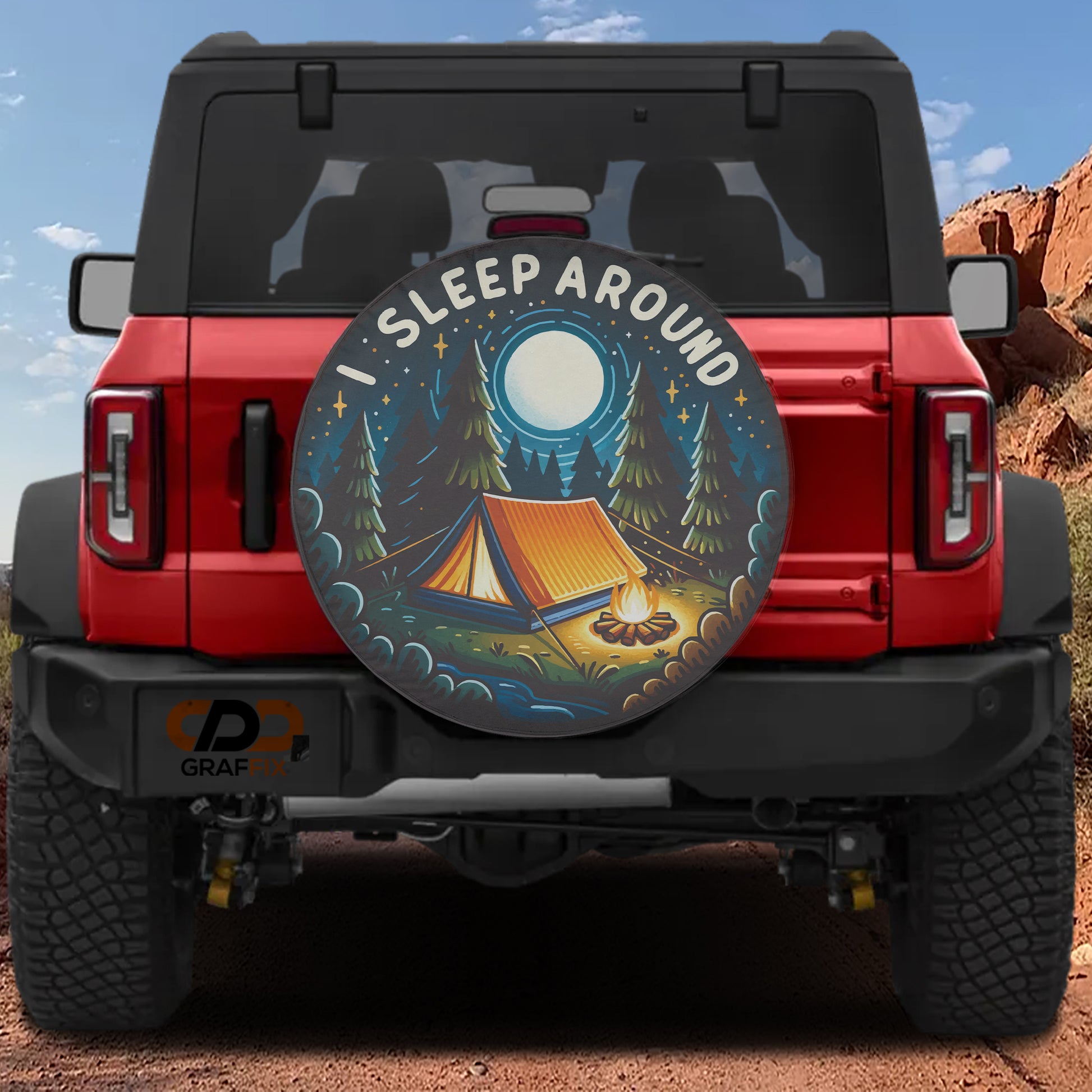 a red Jeep Wrangler with a large, round decal on the rear window that says "I SLEEP AROUND" and depicts a camping scene with a tent, campfire, and trees.