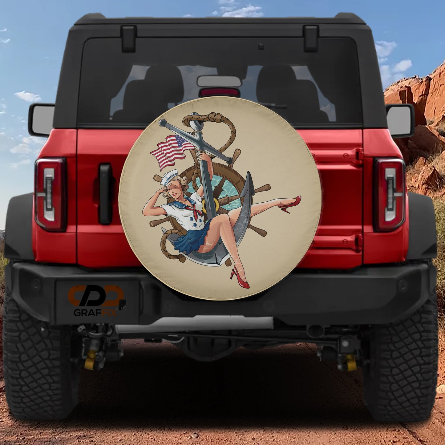 a red Jeep Wrangler with a large round spare tire cover on the rear of the vehicle. The cover depicts a woman wearing a sailor's outfit and holding a steering wheel.