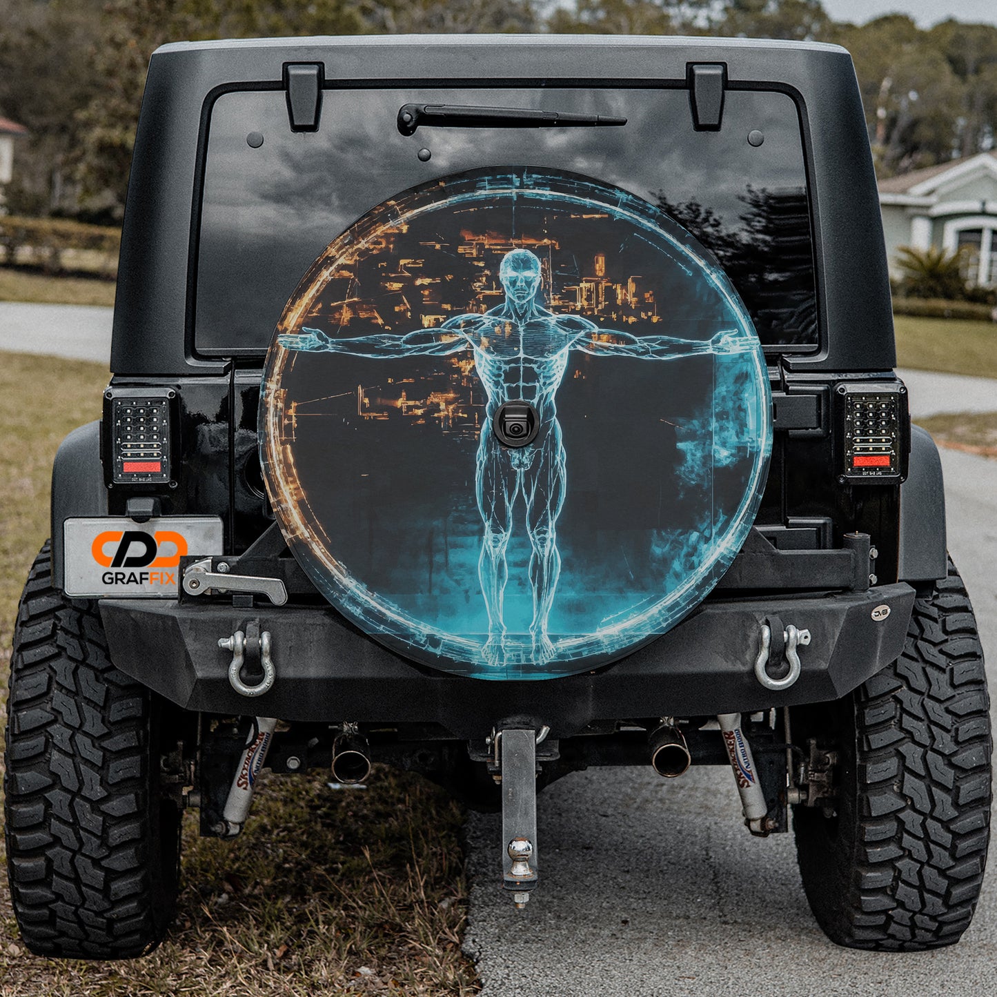 a black Jeep Wrangler with a large rear wheel cover that displays a futuristic cityscape and a human figure.