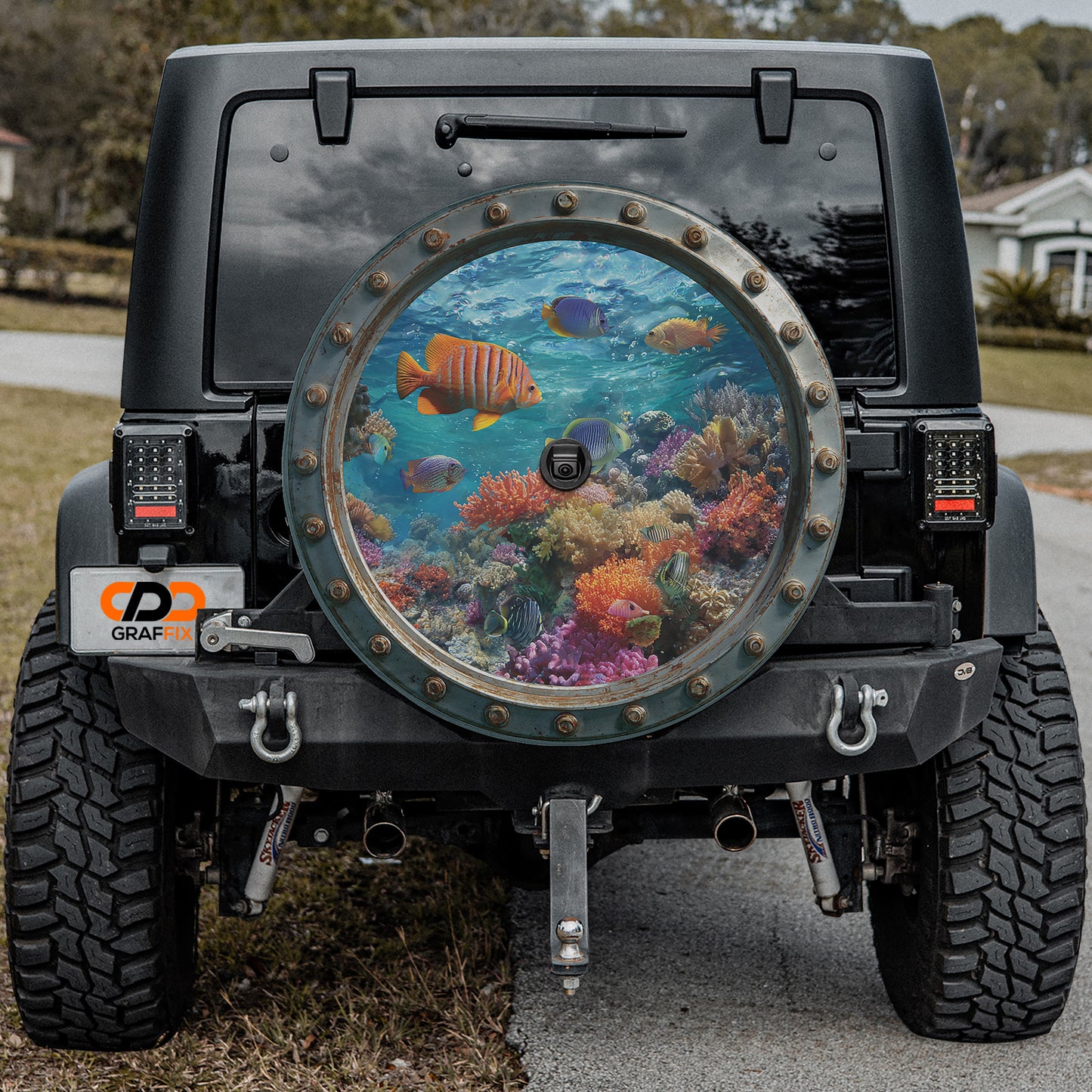 a black jeep with a large, circular window on the back, which displays a vibrant underwater scene with colorful fish swimming among coral and other marine life.