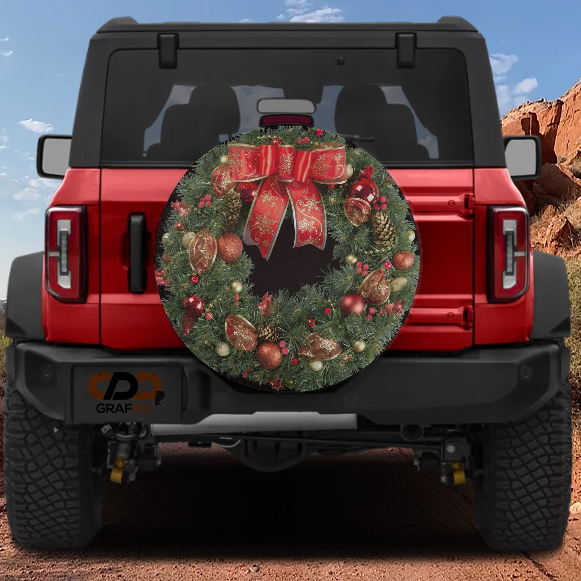 the back of a red Jeep Wrangler with a large Christmas wreath attached to the rear bumper.