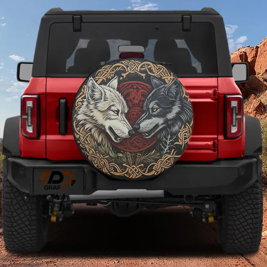 a red Jeep Wrangler with a large, decorative tire cover featuring two wolves facing each other.