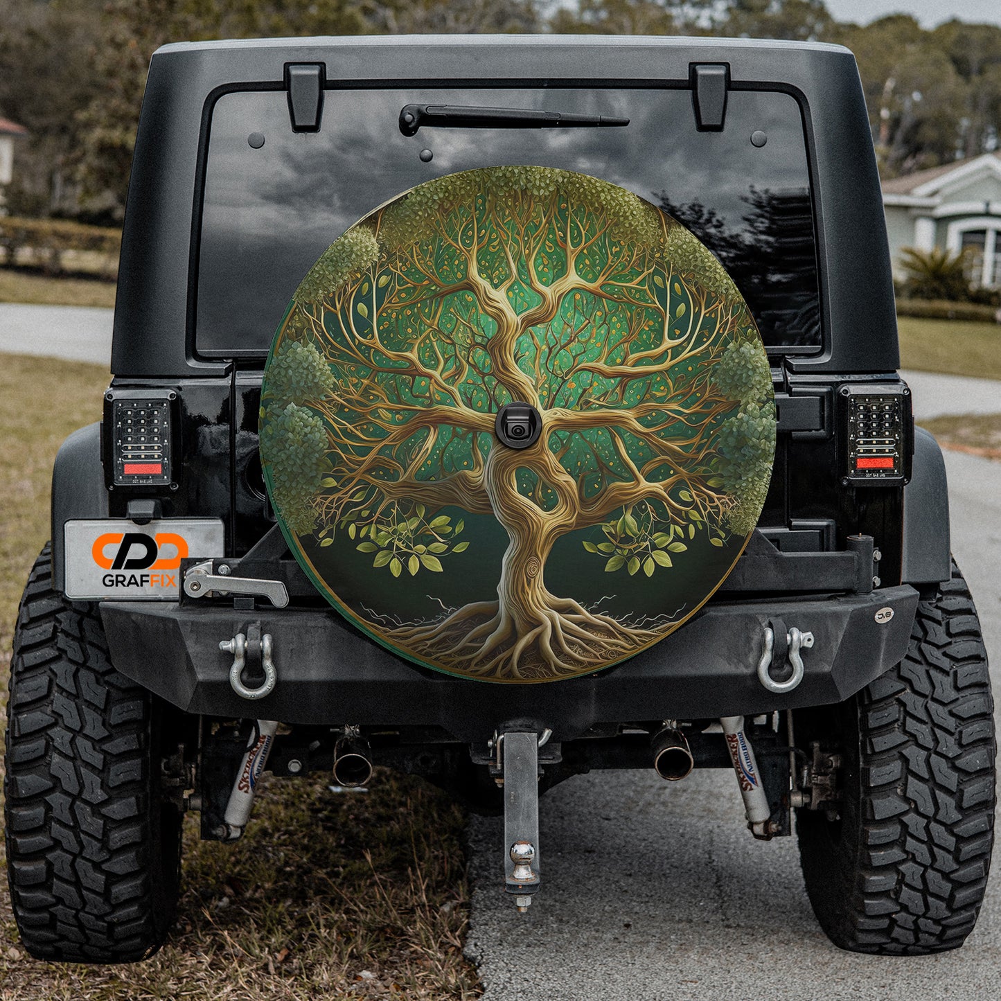a tire cover with a tree painted on it