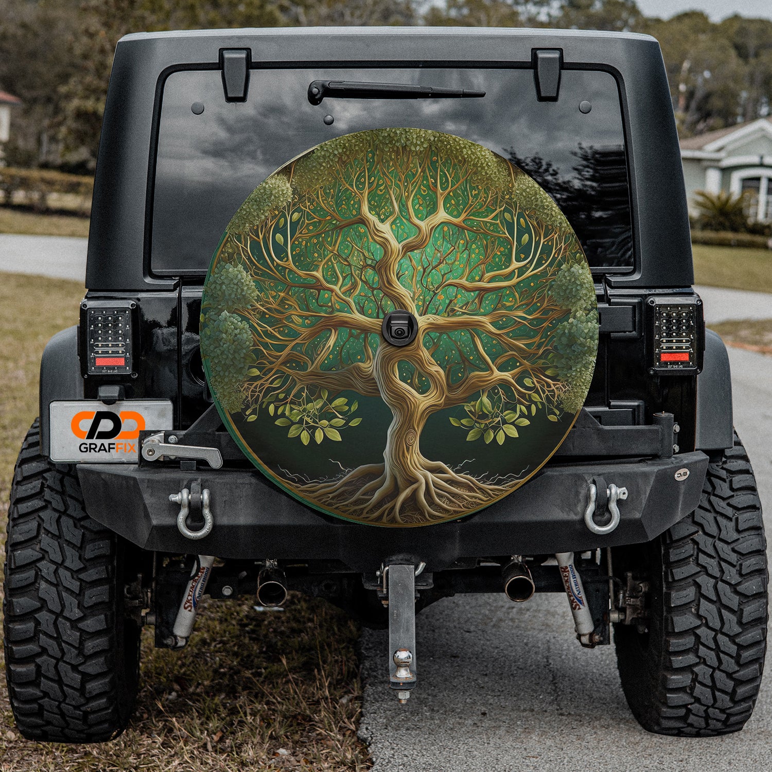 a tire cover with a tree painted on it