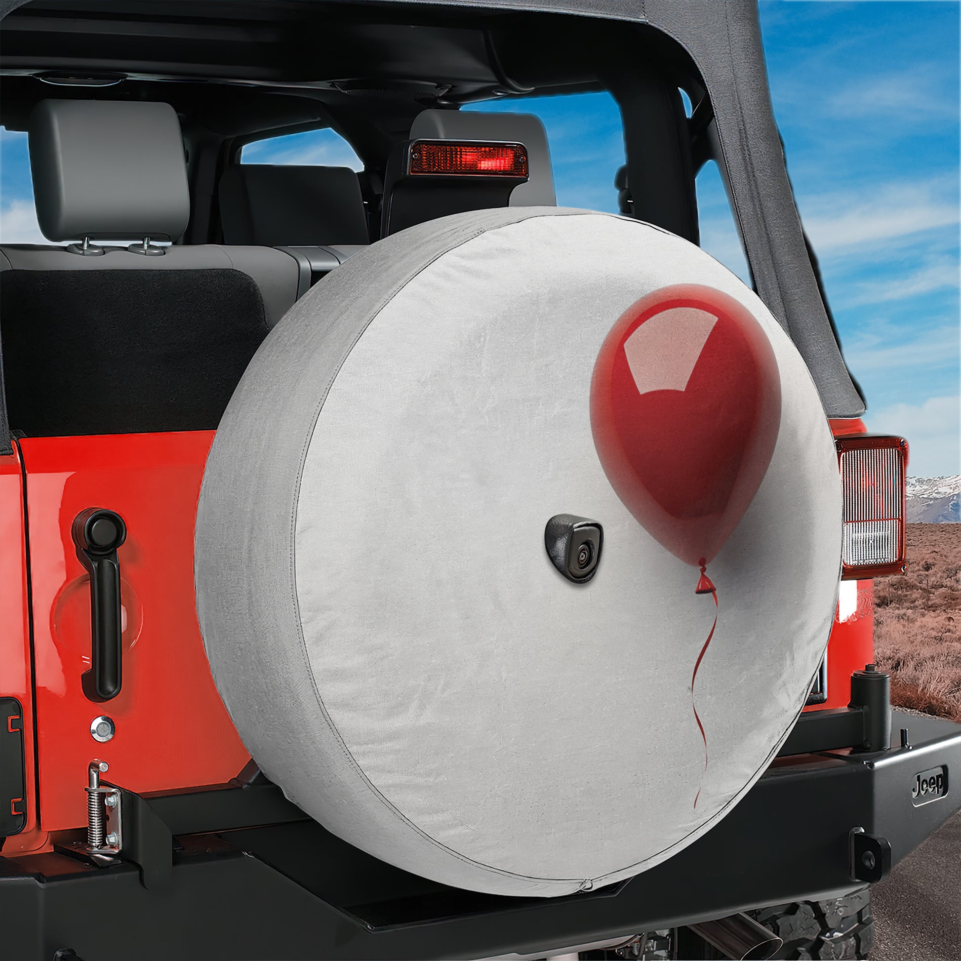 A red Jeep Wrangler with a spare tire attached, featuring a red balloon attached to the spare tire.