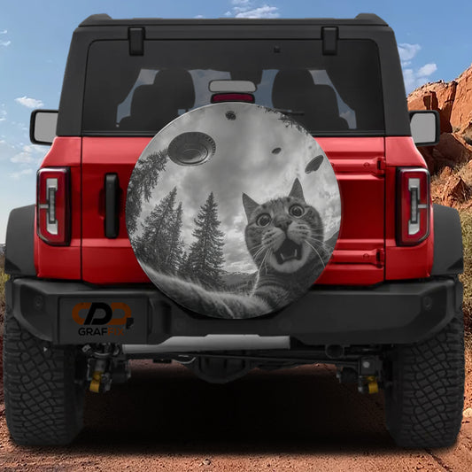 a red Jeep Wrangler with a large tire cover on the rear of the vehicle. The cover depicts a cat with a spaceship in the background, creating a whimsical and imaginative scene.