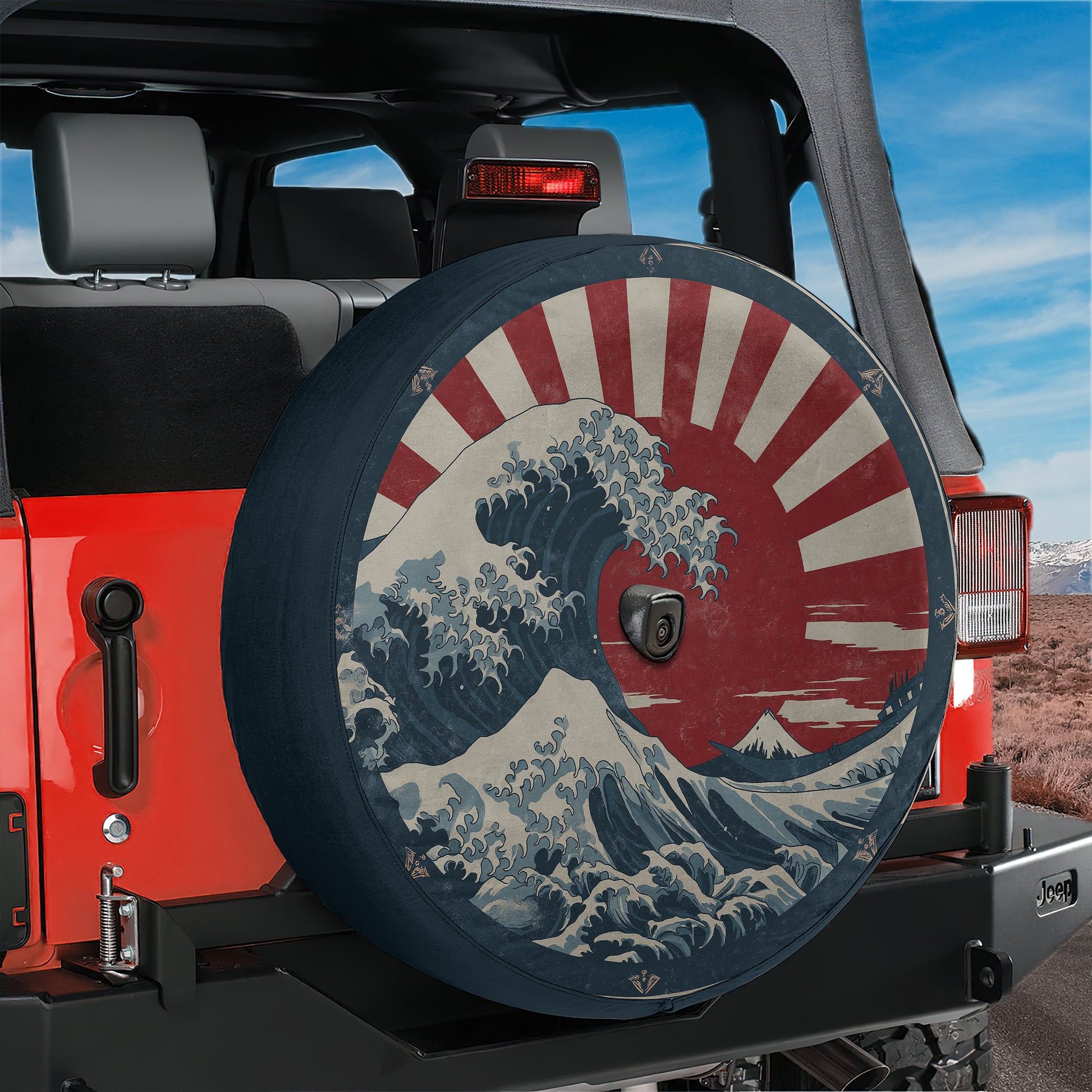A red Jeep Wrangler with a large tire cover featuring a Japanese wave design.