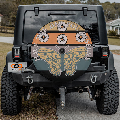 the rear of a black Jeep Wrangler with a large, colorful butterfly decal on the rear window.