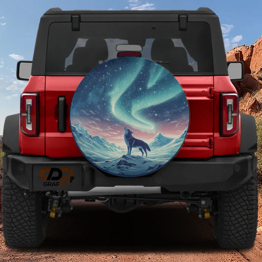 a red Jeep Wrangler with a large, circular spare tire cover depicting a wolf howling at the moon.