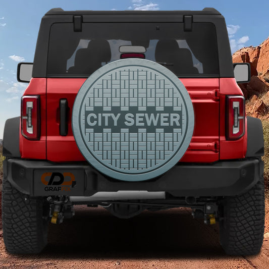 a red Jeep Wrangler with a large silver sewer cover on the rear of the vehicle.