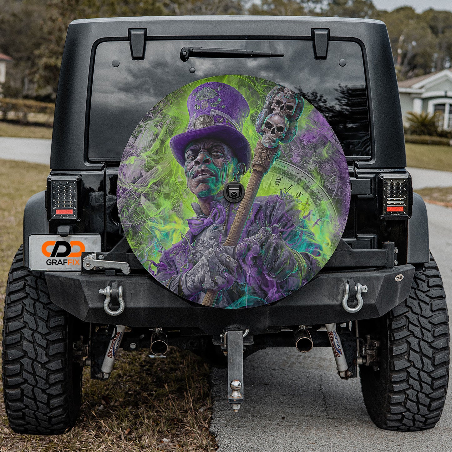 a large, colorful wheel cover with a man wearing a top hat and holding a cane, which is mounted on the rear of a black vehicle.