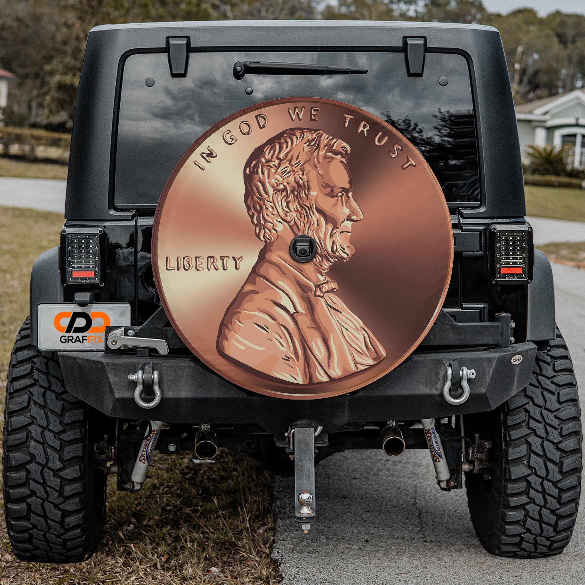a black Jeep Wrangler with a large, round, copper-colored license plate on the rear of the vehicle.