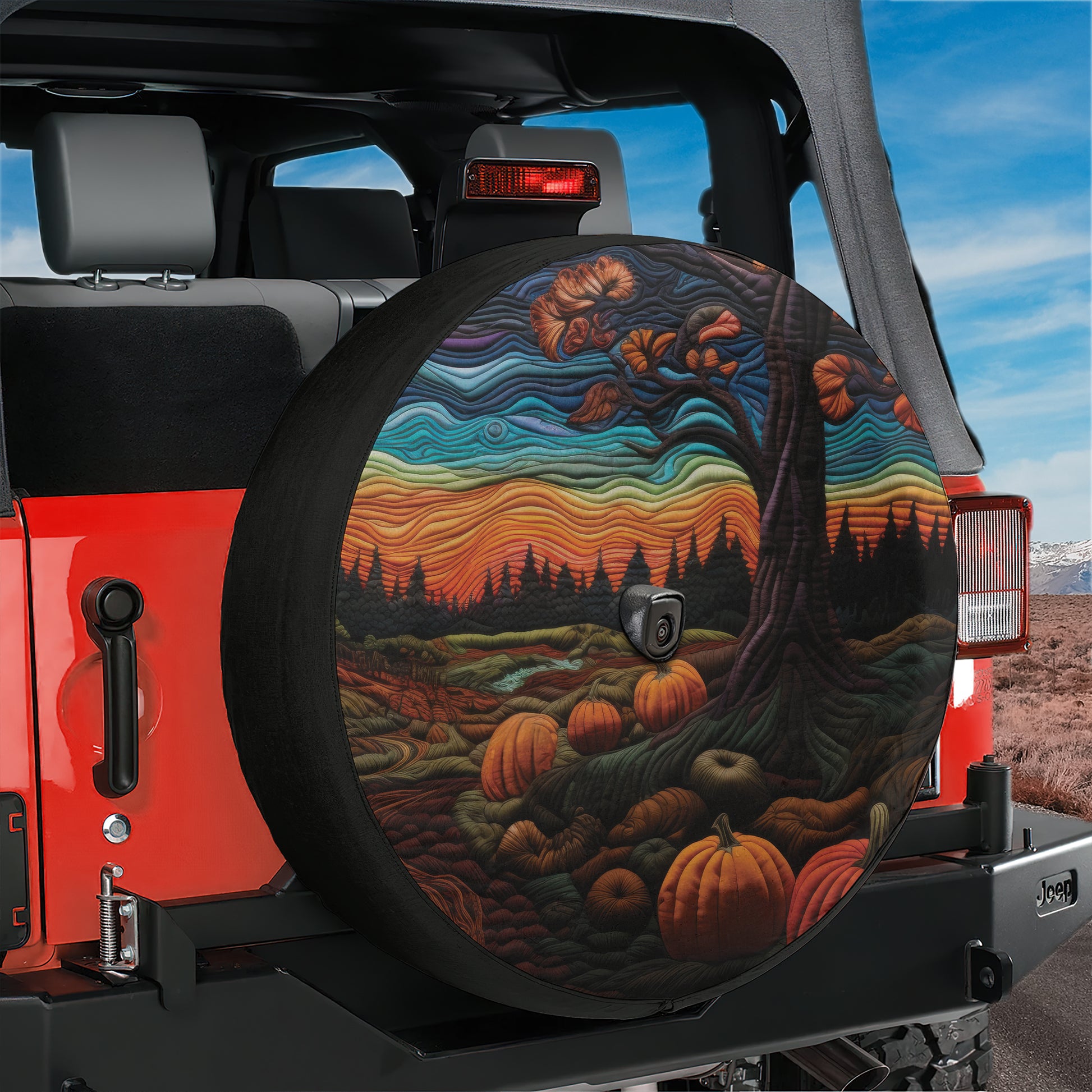 A colorful, artistic design of a tree with autumn leaves and pumpkins on the back of a Jeep vehicle.