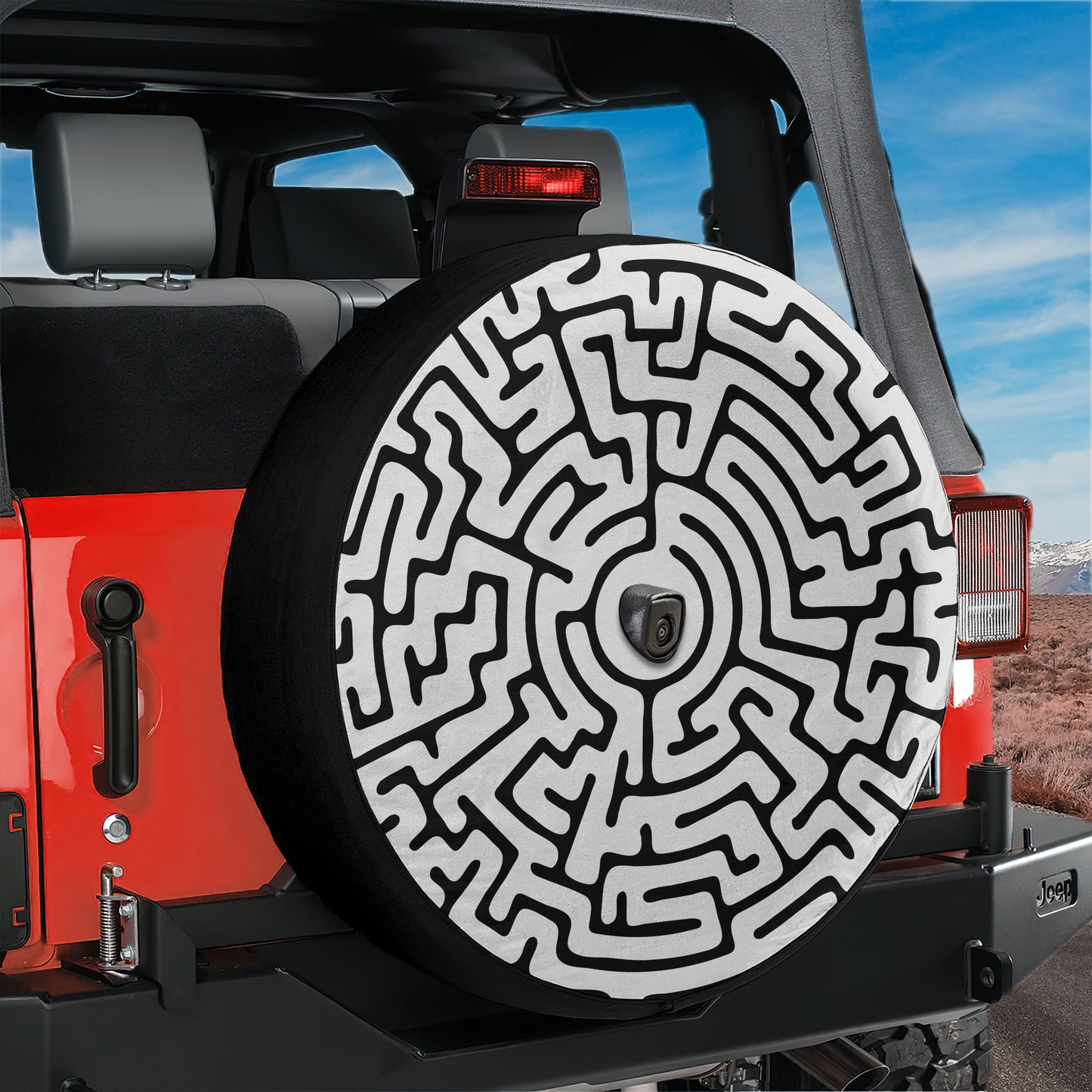 a Jeep vehicle with a large tire cover that has a maze pattern on it.