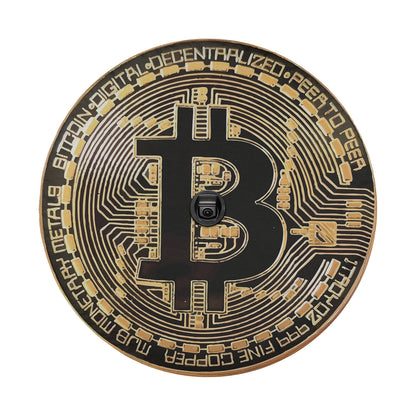 a black and gold plate with a bitcoin on it