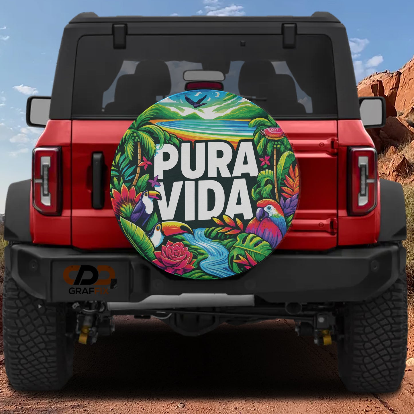 a red Jeep Wrangler with a colorful, tropical-themed spare tire cover on the rear of the vehicle.