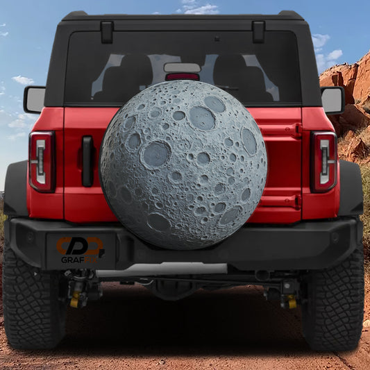 A red Jeep Wrangler with a large moon-shaped spare tire attached to the rear.