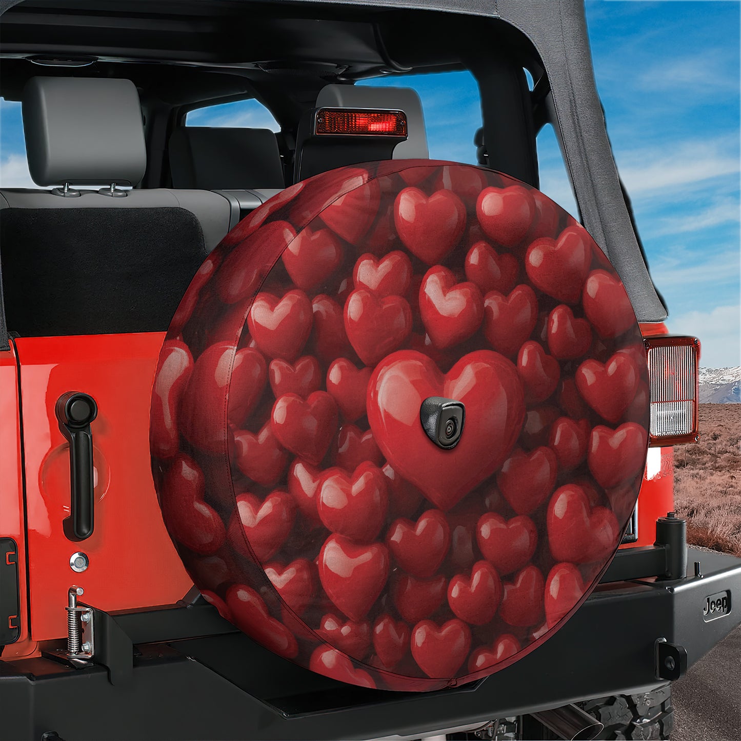 A red Jeep with a heart-shaped spare tire cover attached to the rear of the vehicle.