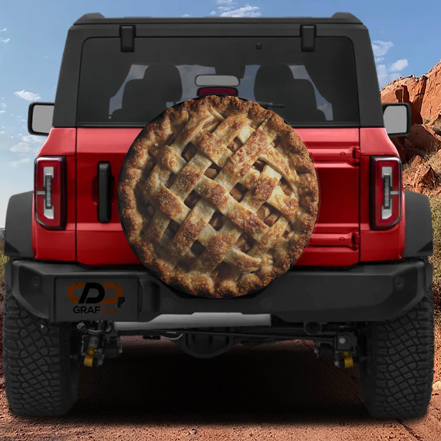 a red Jeep Wrangler with a pie-shaped spare tire attached to the rear of the vehicle.