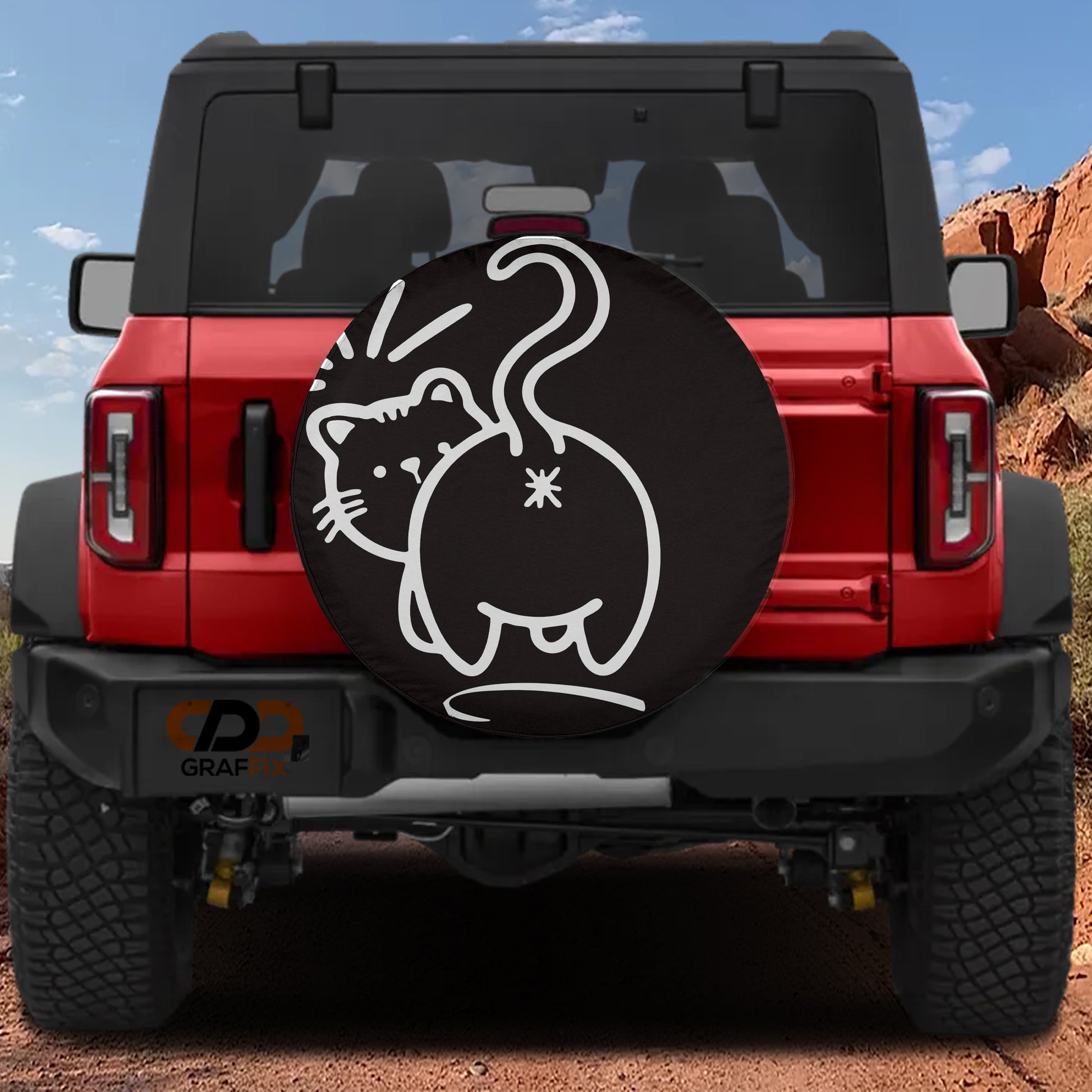 the rear of a red Jeep Wrangler with a black tire cover featuring a cartoon cat design.