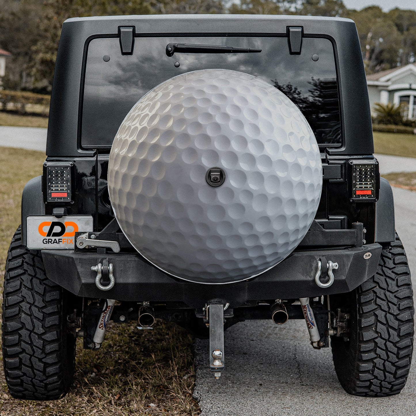 a golf ball on the back of a jeep