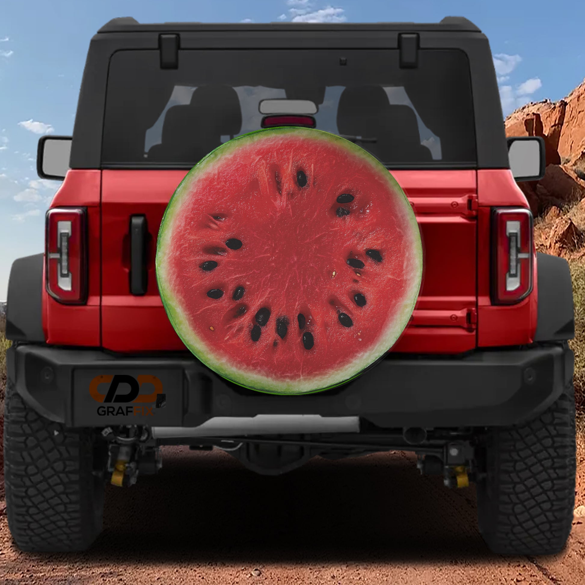 a red Jeep Wrangler with a large watermelon sticker on the rear window.