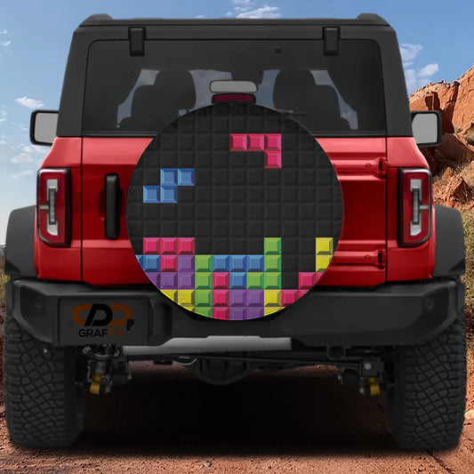 a red Jeep Wrangler with a colorful Tile-based graphics decal on the rear window.