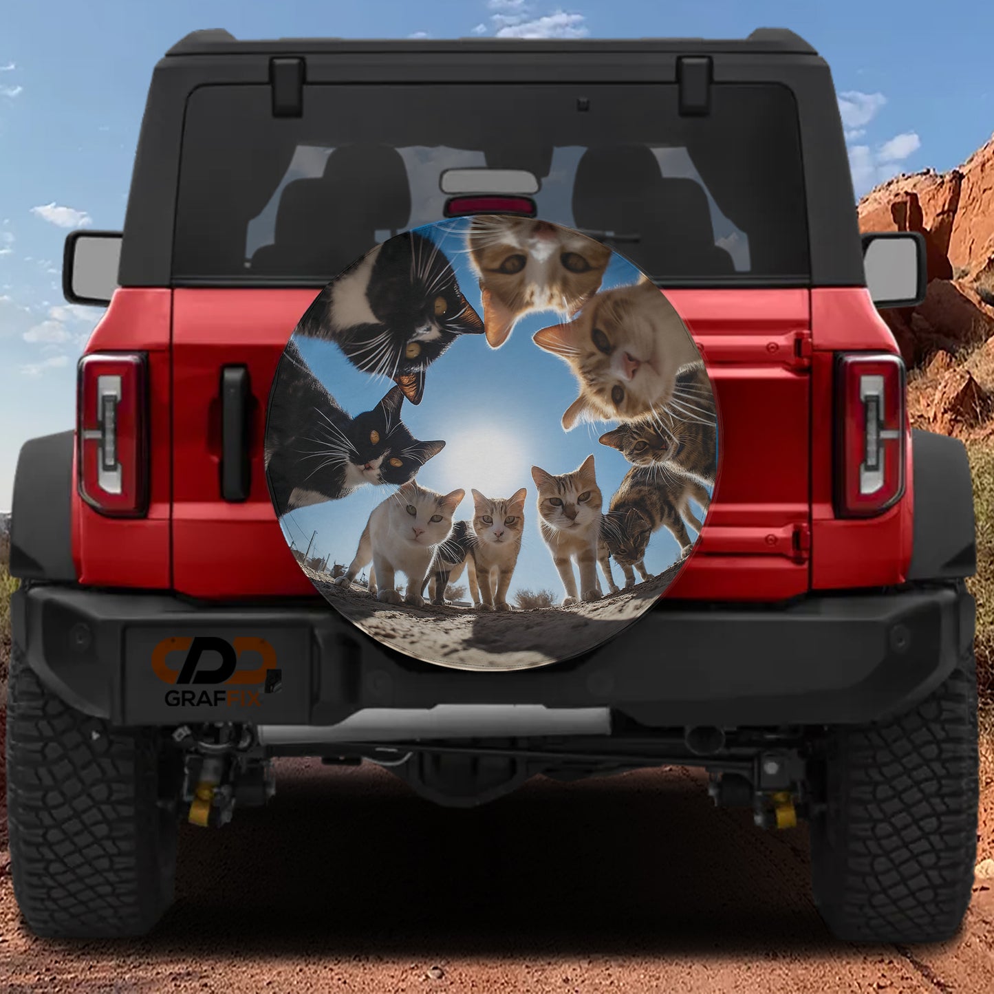 A red Jeep Wrangler with a large round spare tire cover featuring a collage of cats in various poses.