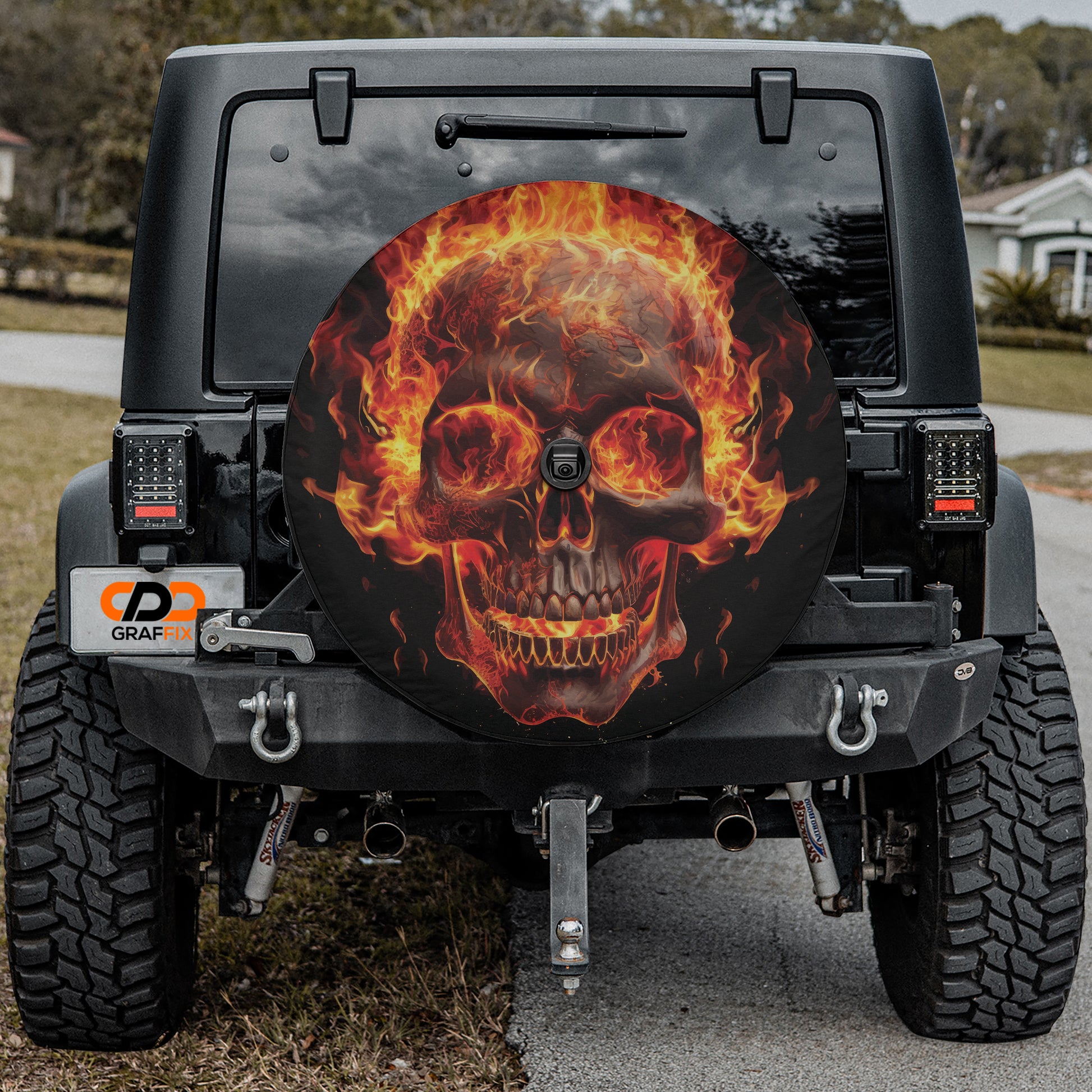 a black Jeep Wrangler with a large, eye-catching skull decal on the rear window.