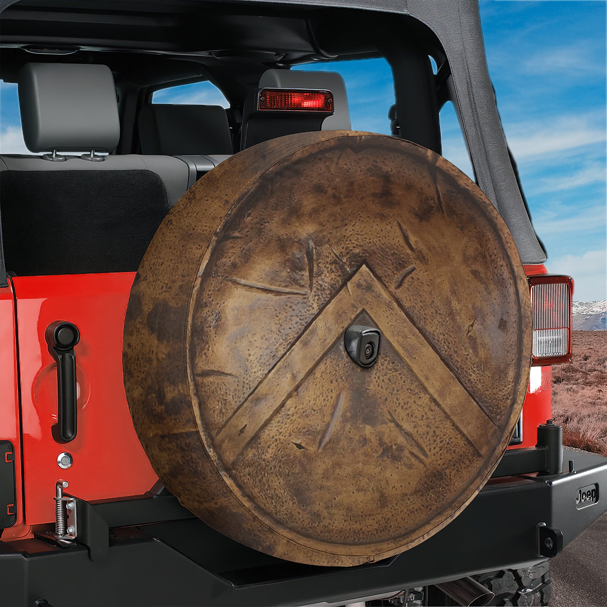 a red Jeep with a large spare tire attached to the rear of the vehicle.