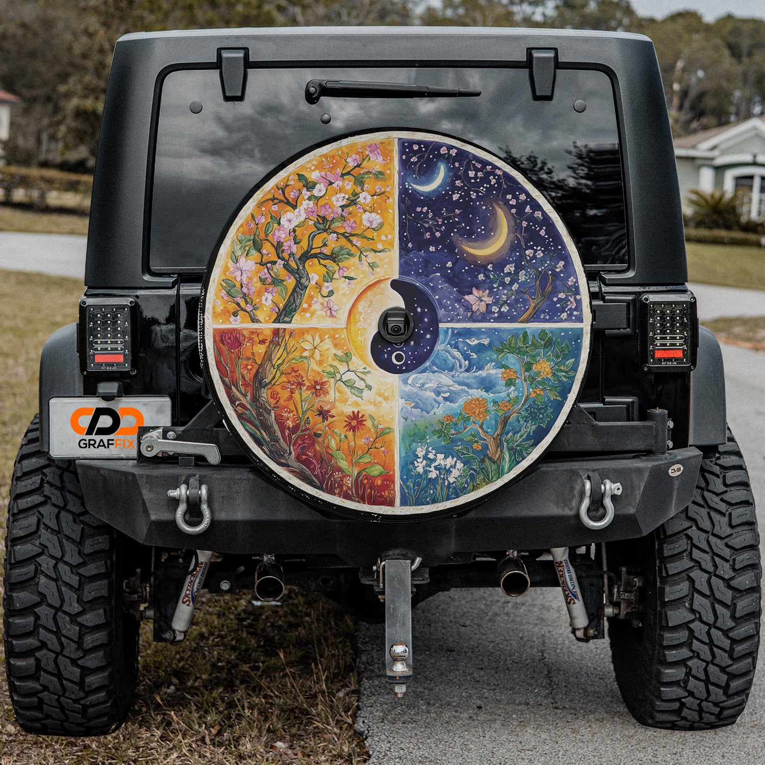 a jeep with a painted wheel cover on the back of it
