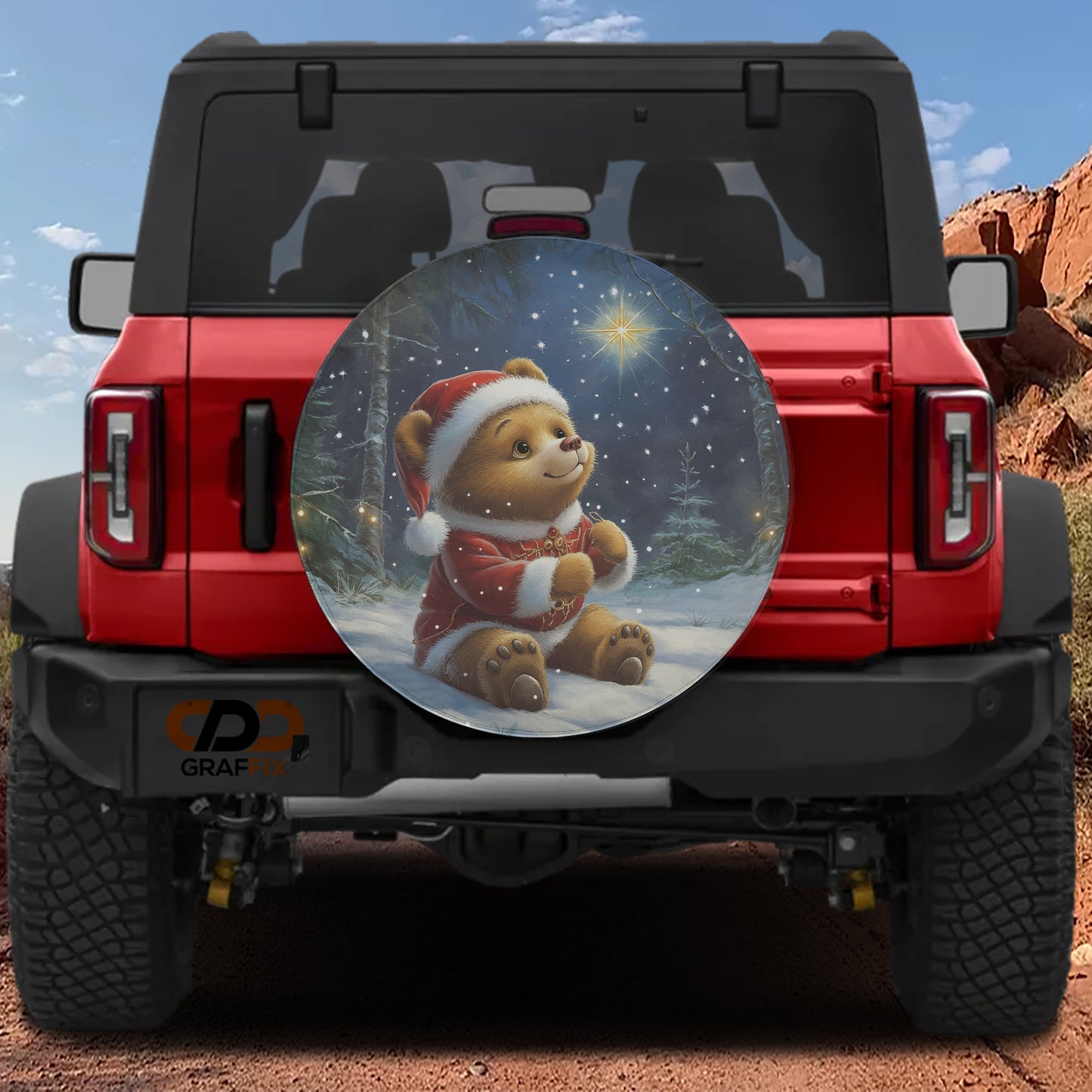 a red Jeep Wrangler with a large, round spare tire on the rear, depicting a teddy bear wearing a Santa hat and holding a star.