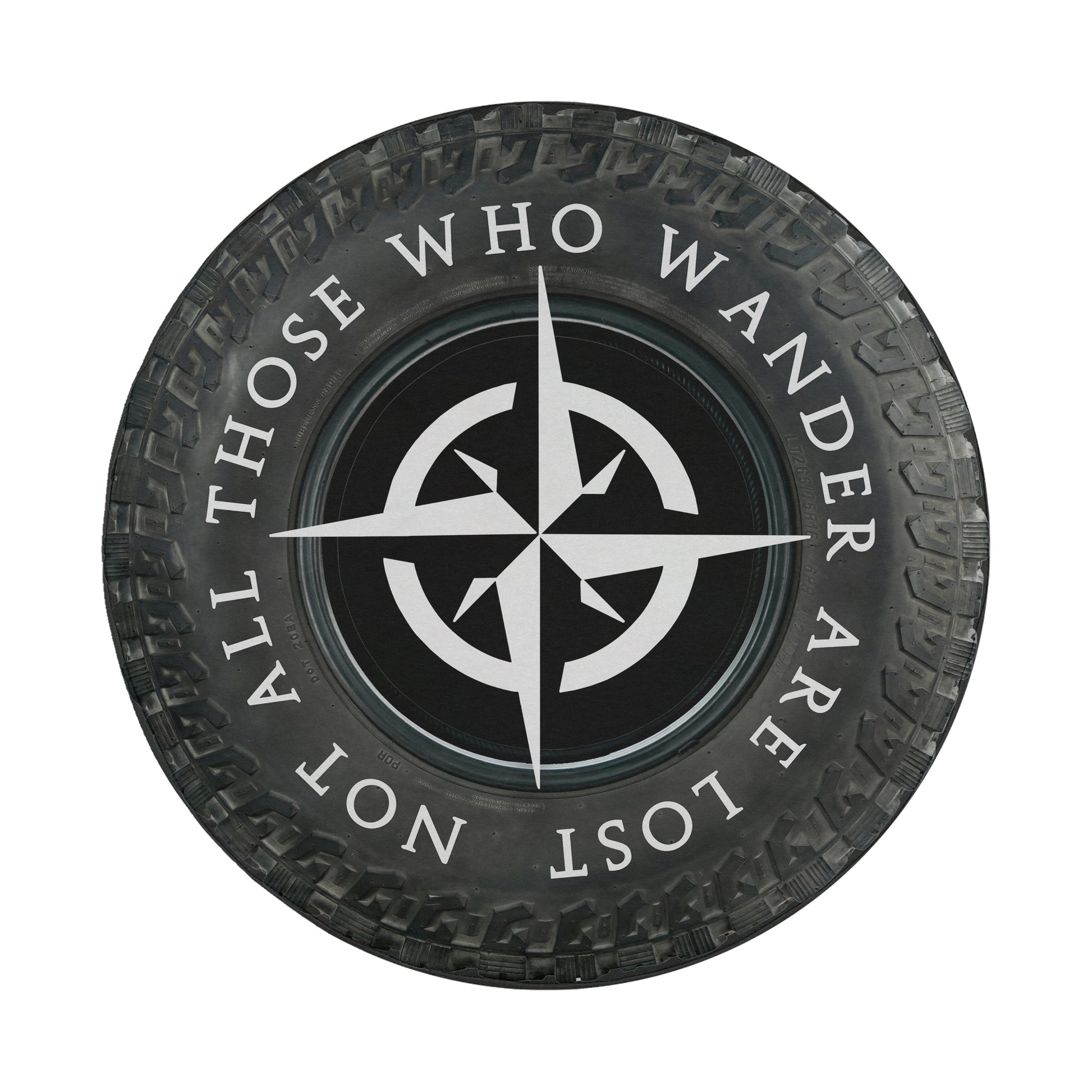 A black and white image of a tire with a compass symbol and the text "ALL THOSE WHO WANDER ARE NOT LOST" printed on it.