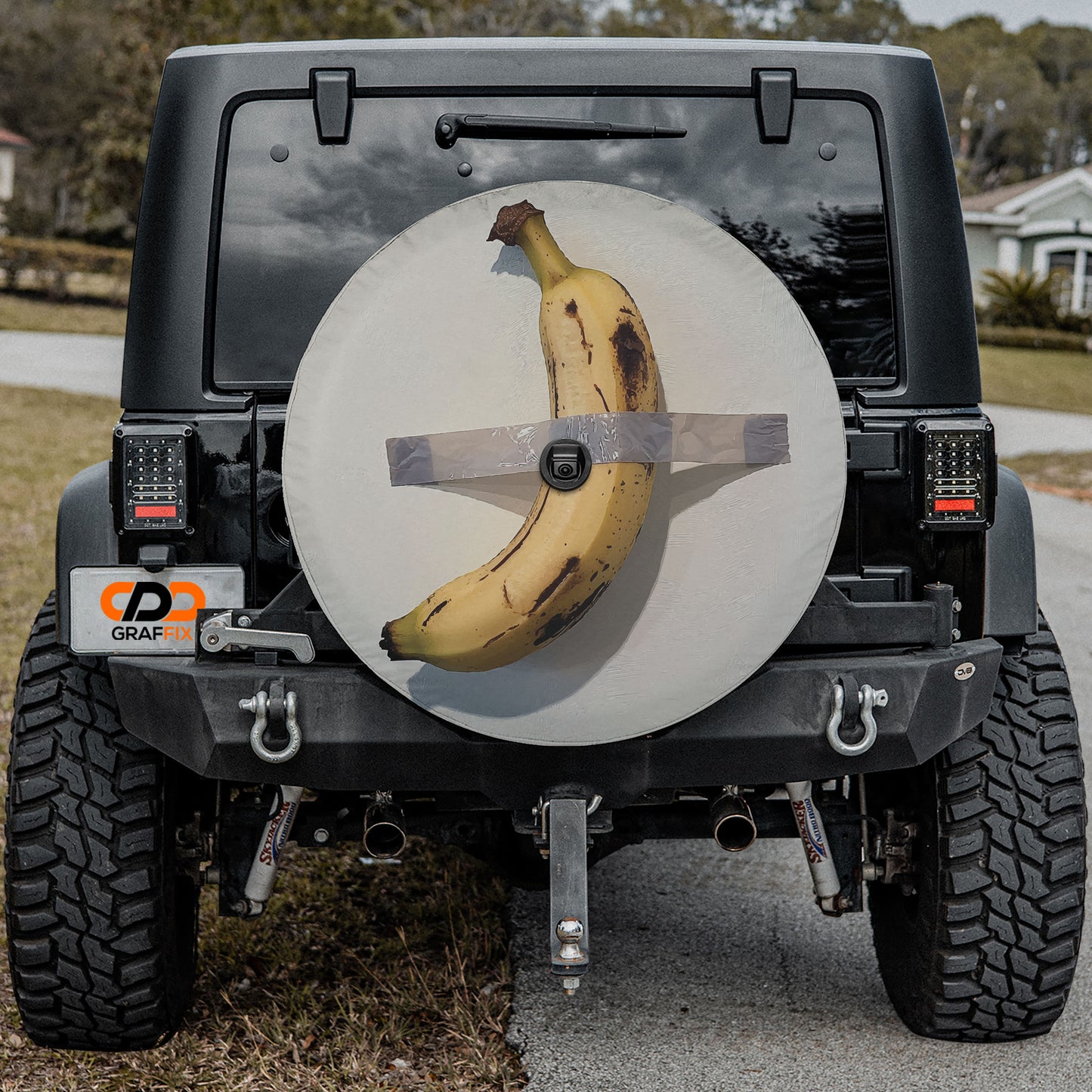 a black Jeep Wrangler with a banana sticker on the rear window.